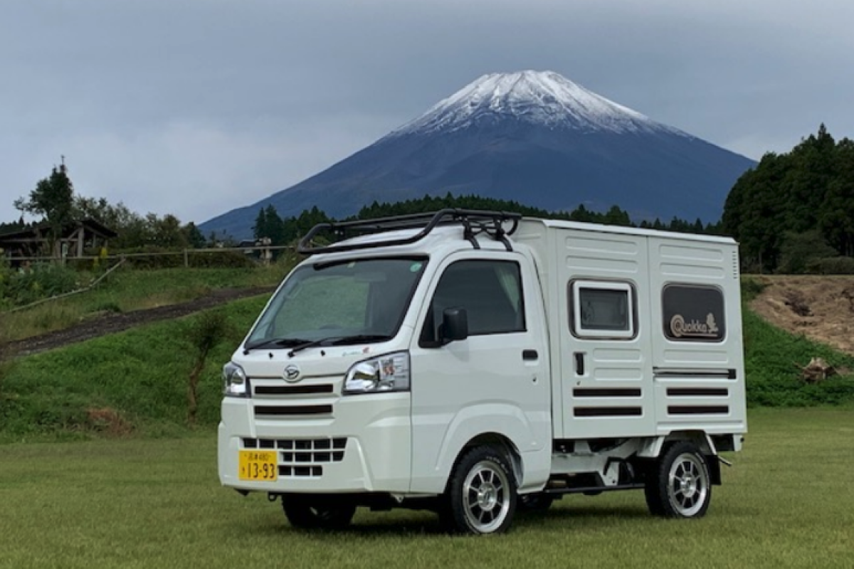 Adorable Hijet micro camper van opens into warm fragrant log cabin